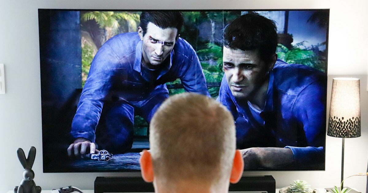 Man watching a movie on a TV in a living room