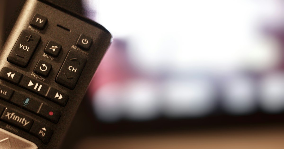 Black remote control on wooden table